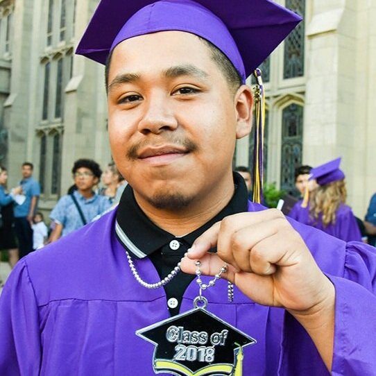 Learning Works Charter School graduate of 2008 in a purple cap and gown.