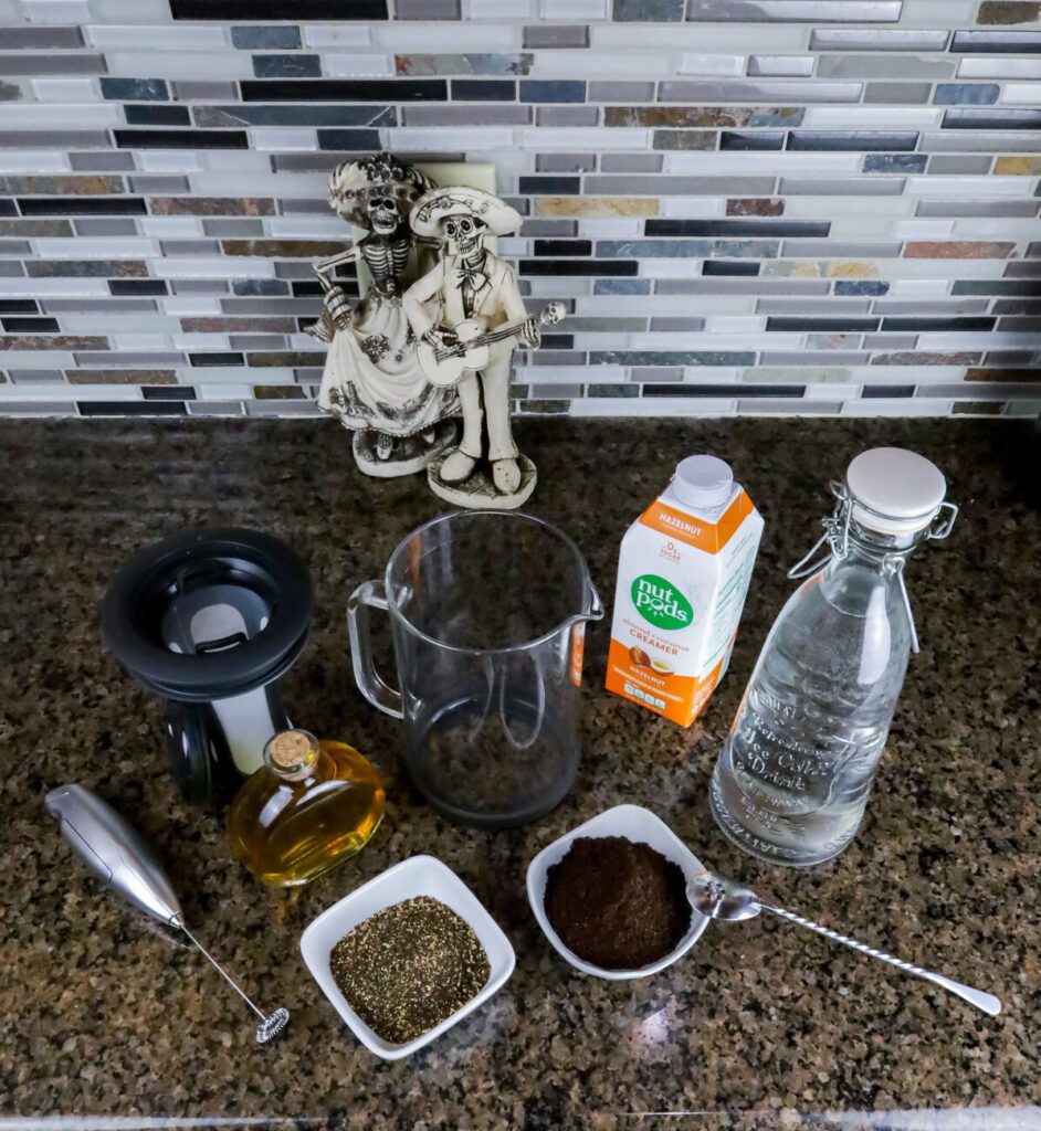 All the tools needed to make the recipe laid out on a counter. - Keto Cold Brew Coffee Recipe